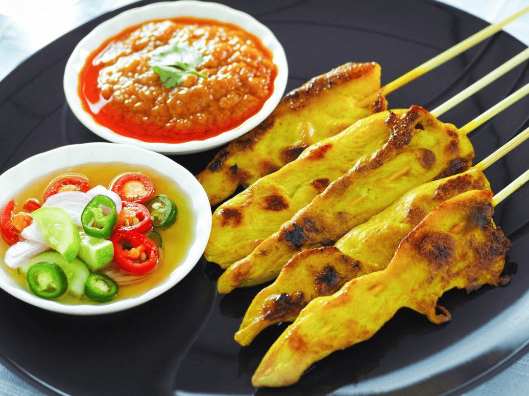 Thai chicken satay skewers with peanut sauce and cucumber chili relish