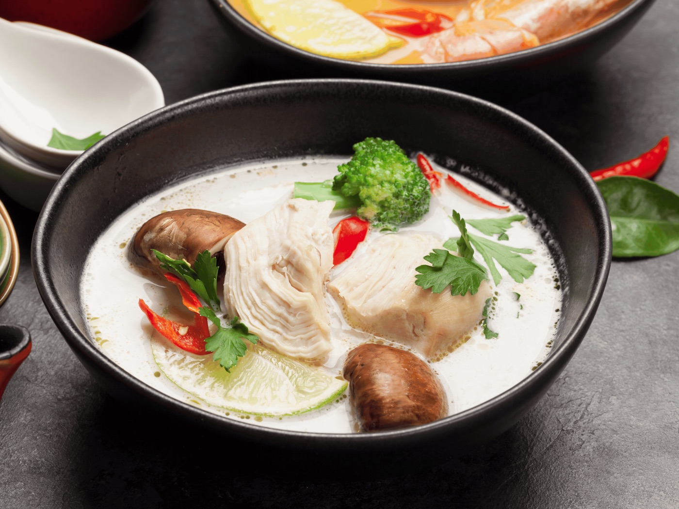 Thai coconut soup with chicken, mushrooms, broccoli, lime, and chili